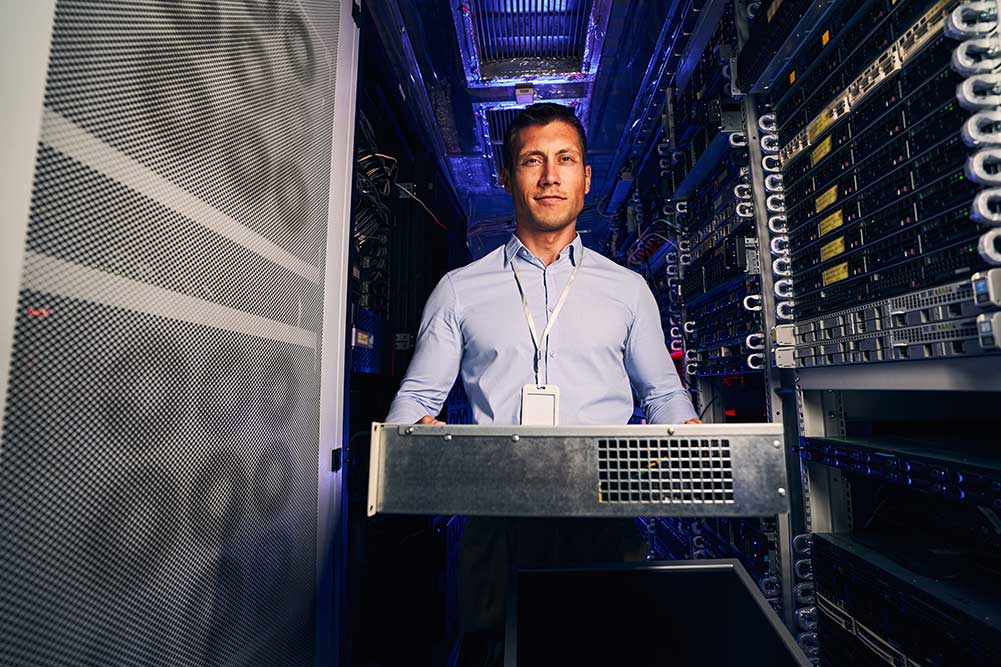 image of a man moving a server rack unit